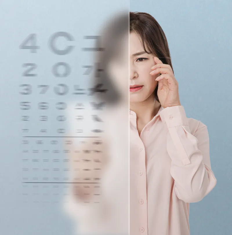 Woman rubbing her eye beside an eye chart that is clear on one side and blurred on the other