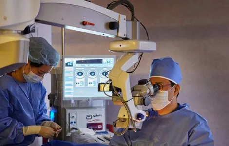 Ophthalmic surgeons operating under a microscope during glaucoma surgery