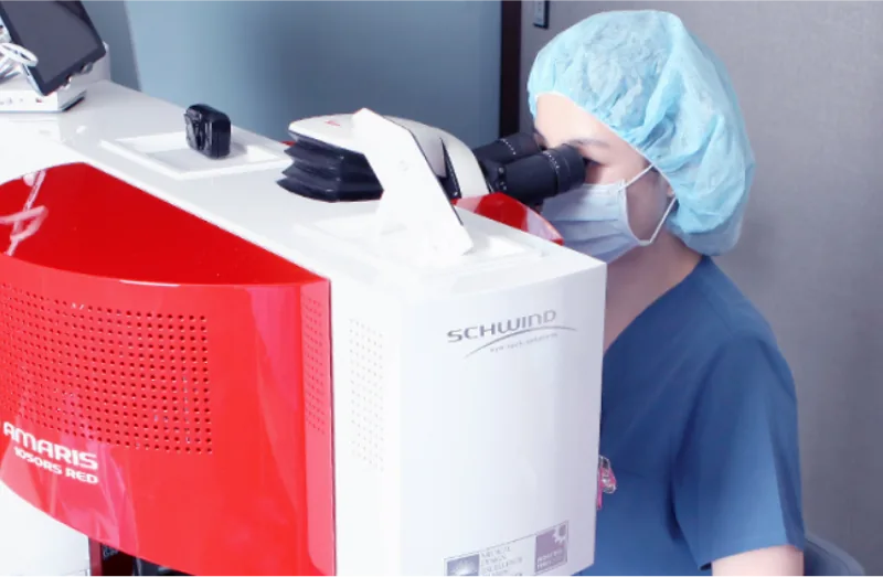 Medical staff operating an excimer laser during LASEK surgery